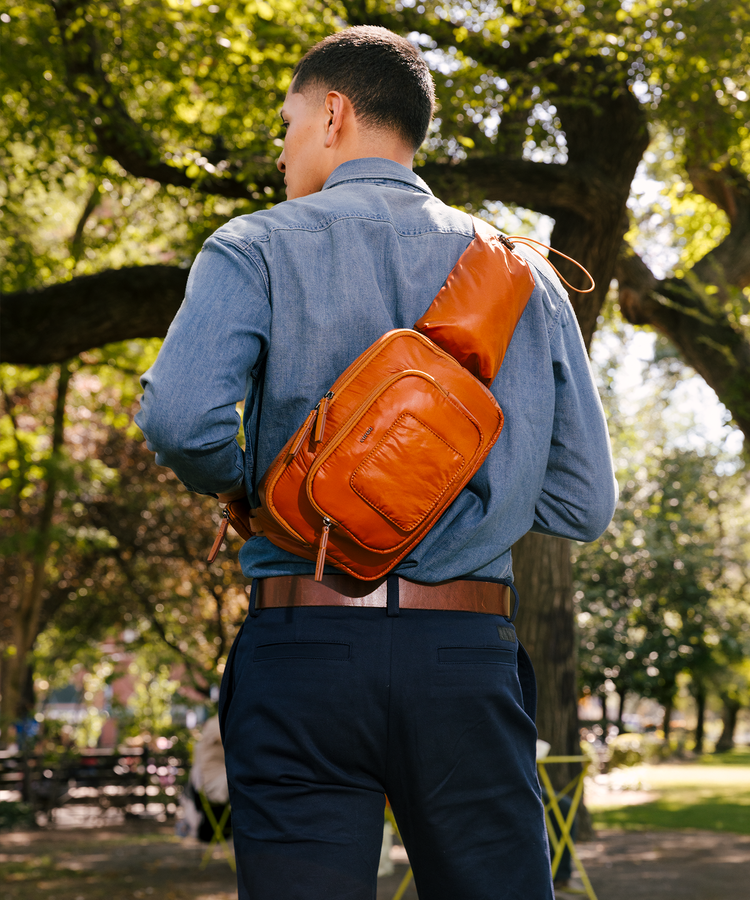 Man wearing a clay sling in a park setting