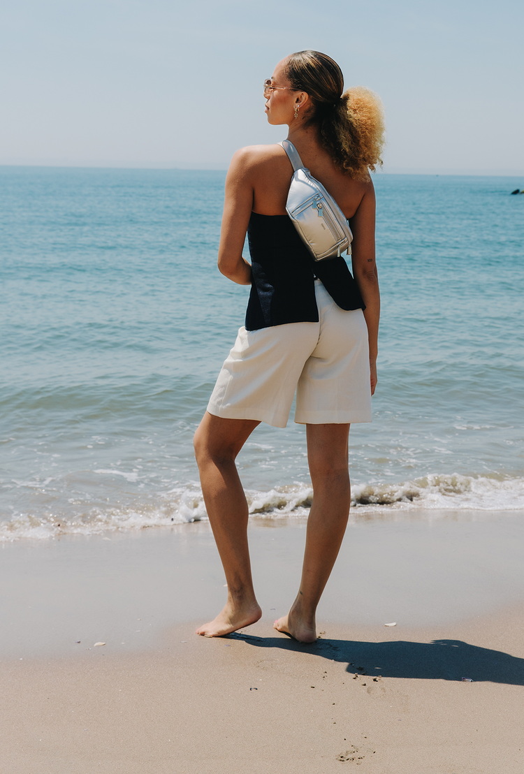 Woman standing on a beach with ocean view